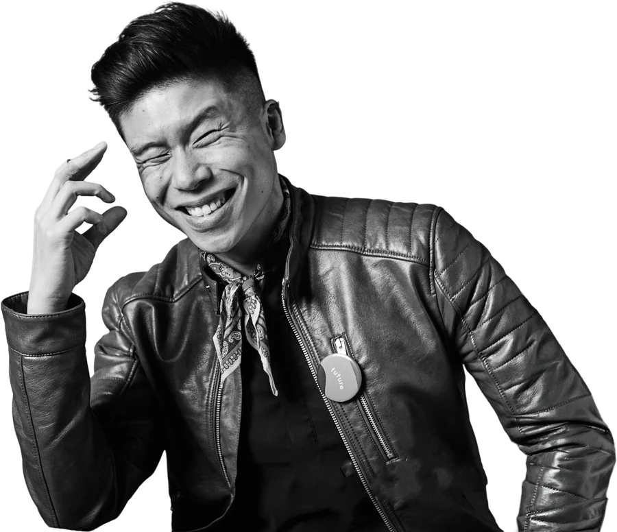 Dave Leong laughing in a black leather jacket and paisley scarf